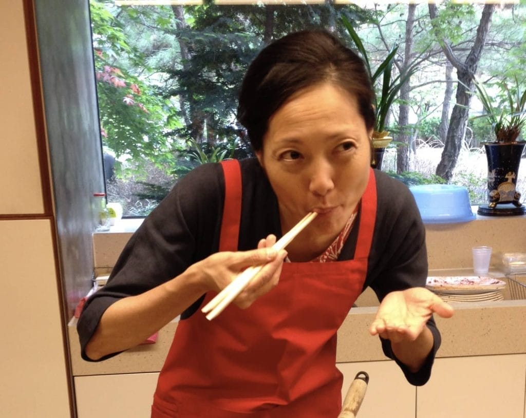 A woman wearing a red apron.
