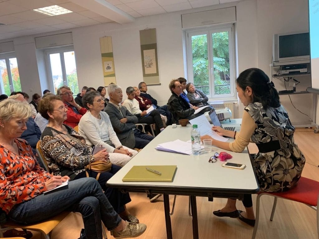 A group of people sitting around a table in a room.