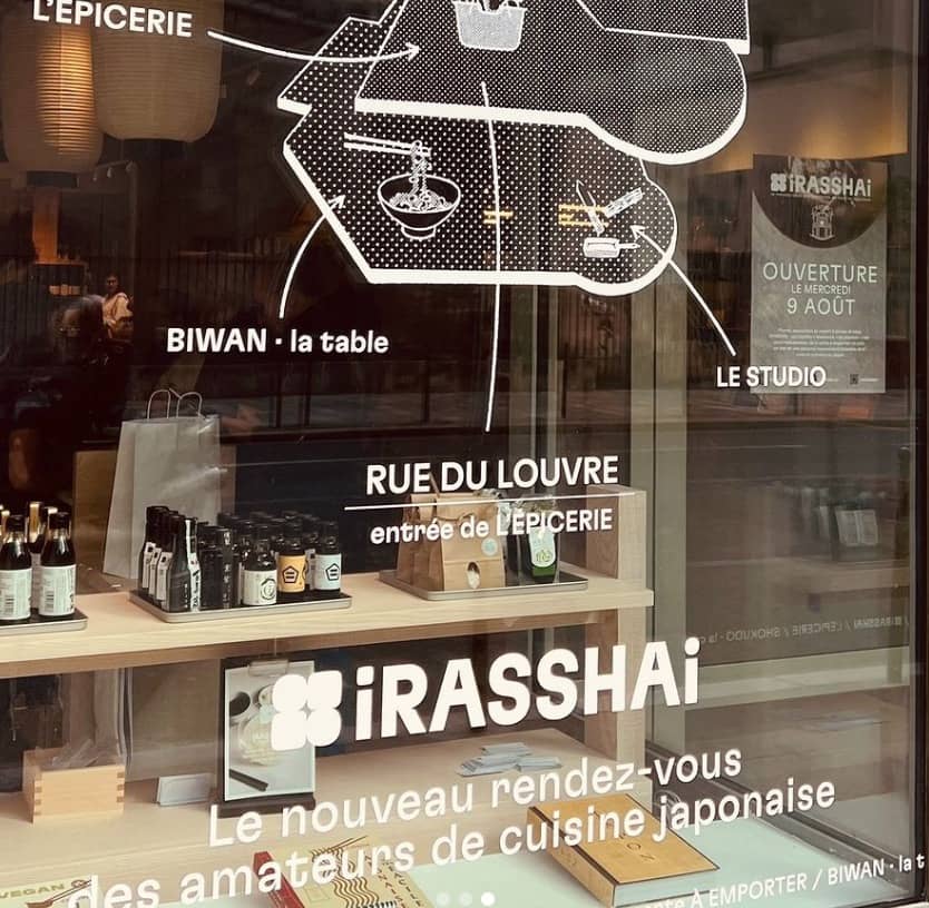 A window display of a restaurant with a sign for irashat.